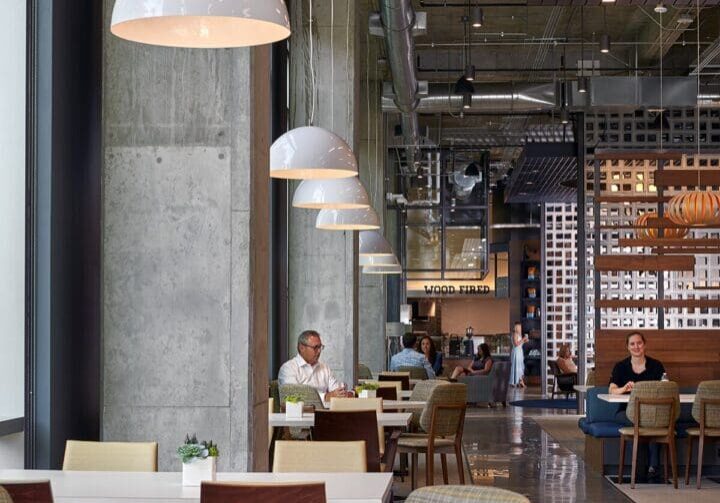 Modern cafe interior with hanging lamps and cozy seating.