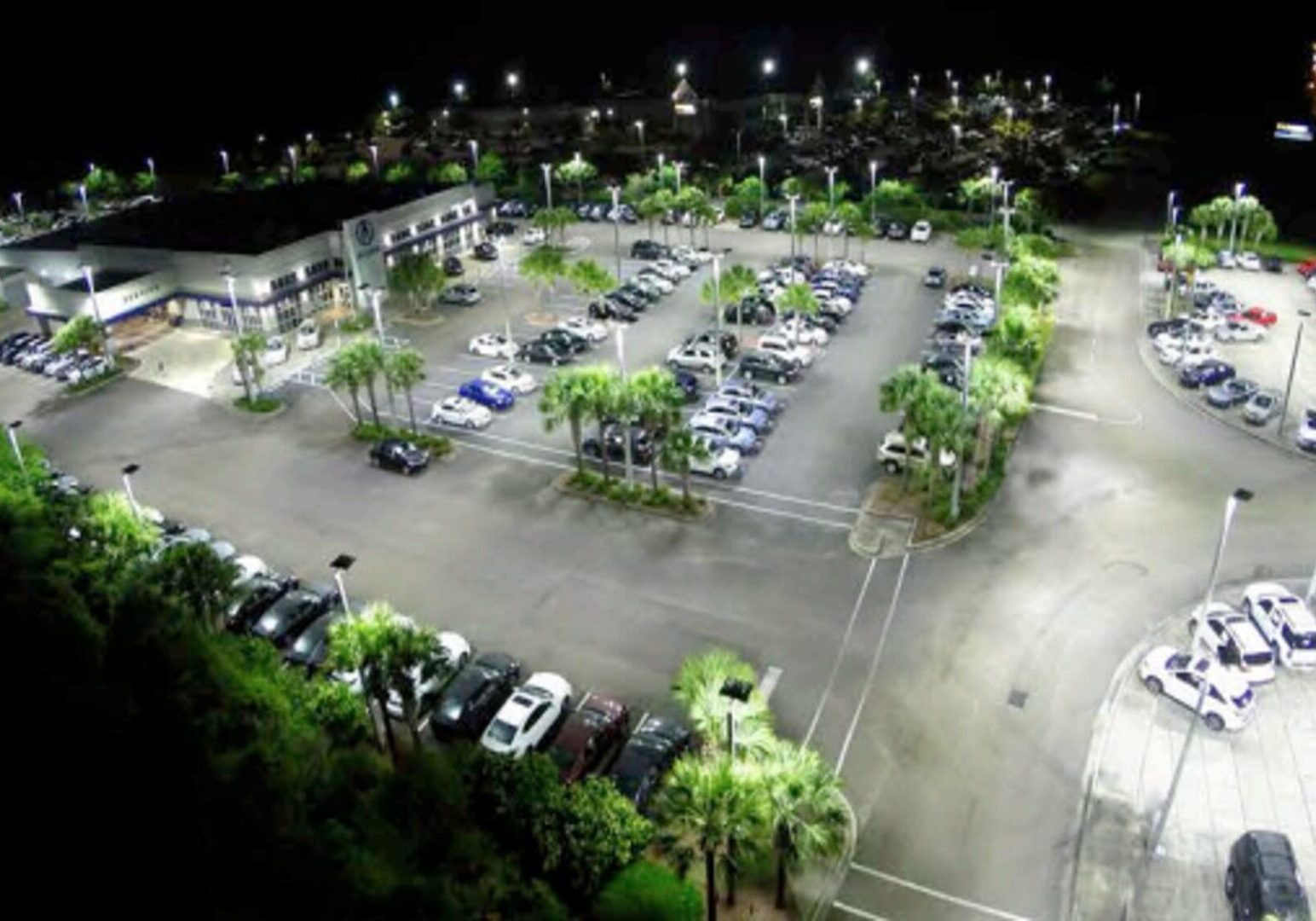 A parking lot with many cars parked in it